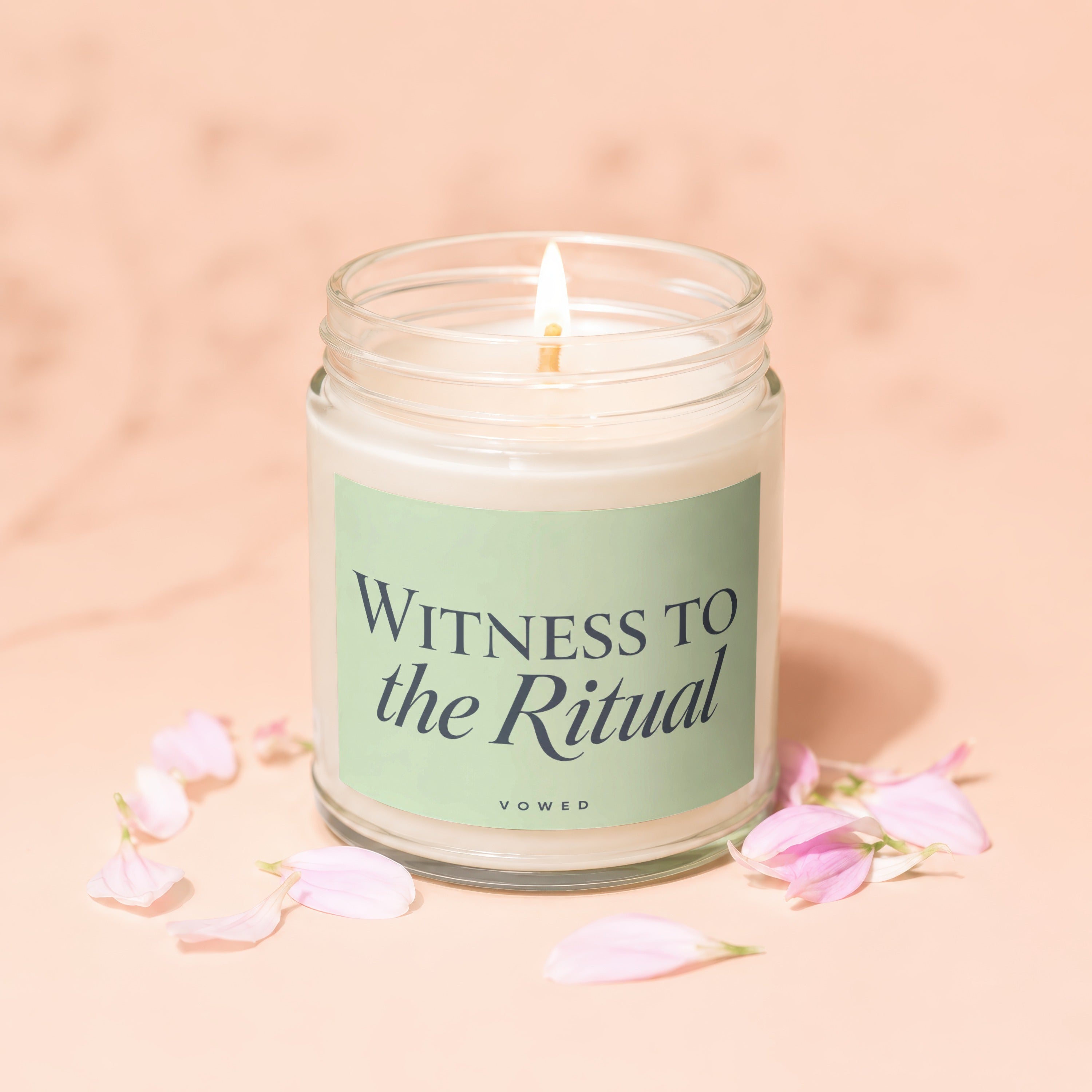 Jar candle with lit wick labeled "WITNESS TO the Ritual VOWED."