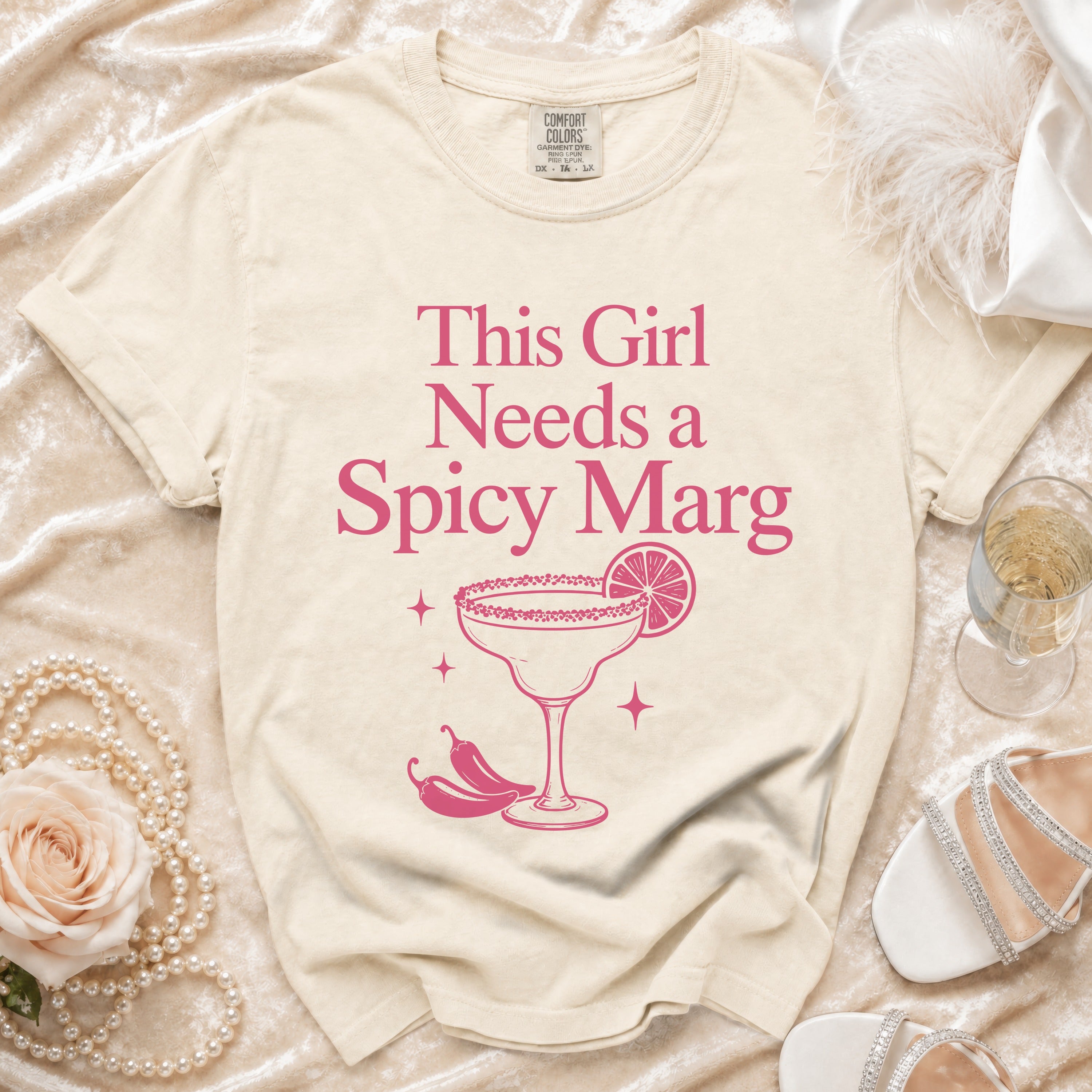 Cream t-shirt with "This Girl Needs a Spicy Marg" graphic.