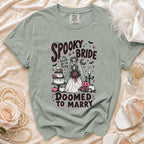 T-shirt graphic of a skeleton bride with text "Spooky Bride" and "Doomed to Marry".