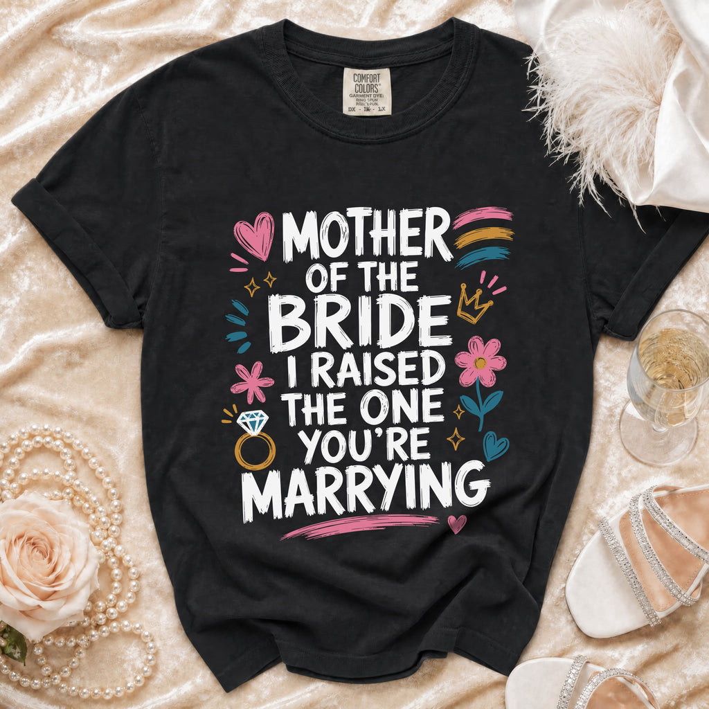 Black t-shirt with "Mother of the Bride, I Raised The One You're Marrying" text and graphics.