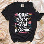 Black t-shirt with "Mother of the Bride, I Raised The One You're Marrying" text and graphics.