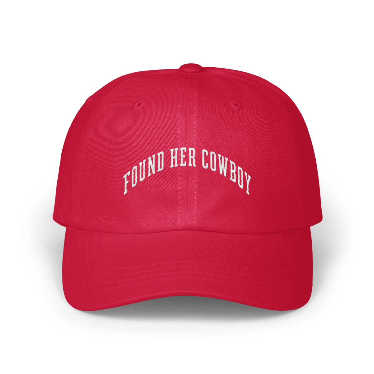 A red baseball cap with white embroidered text reading "FOUND HER COWBOY" arched across the front.