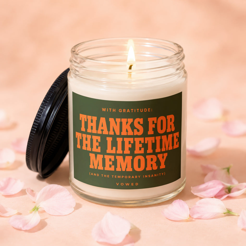 Candle with burning wick on pink background, reads "Thanks for the lifetime memory".