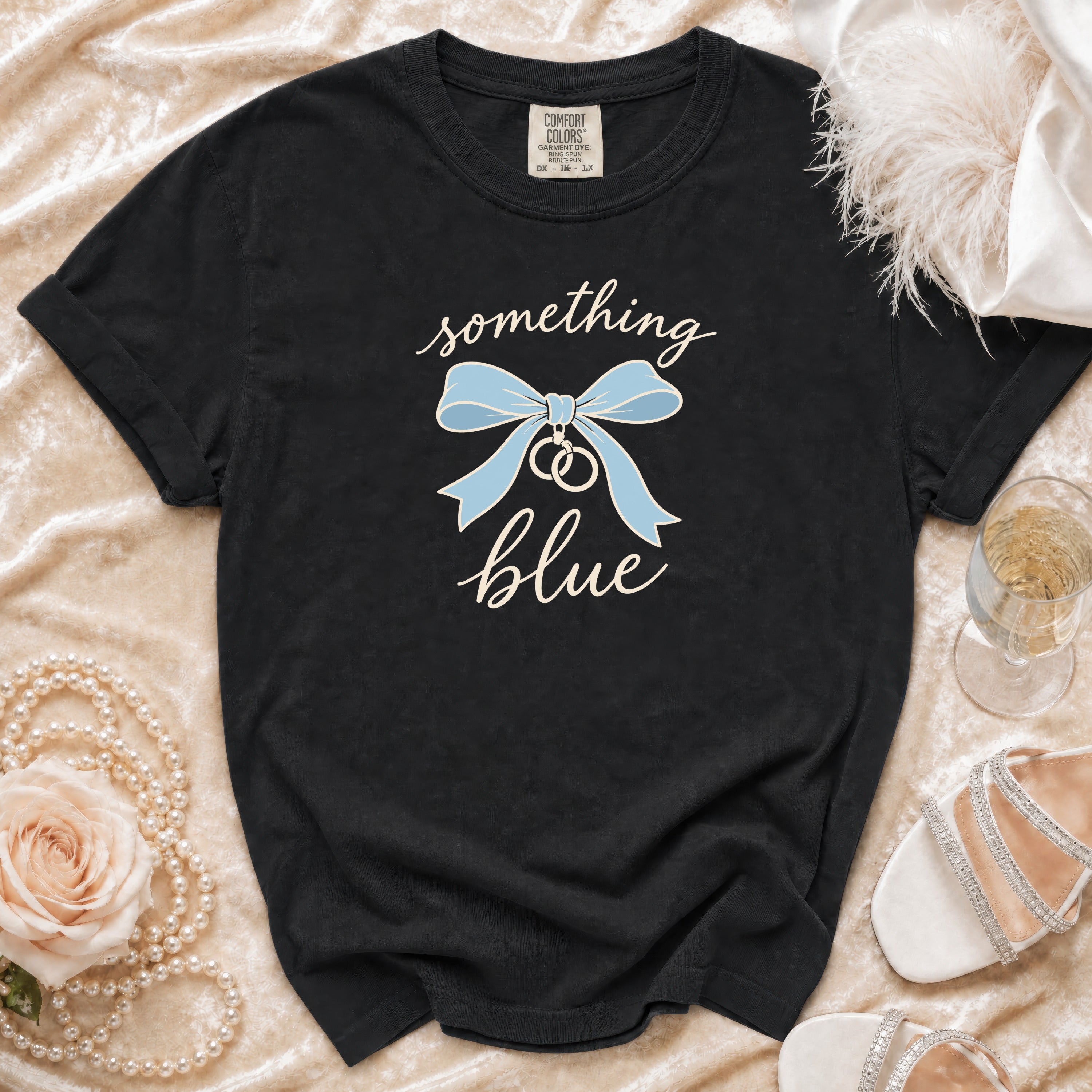 Black Comfort Colors t-shirt with "something blue" text and blue bow with rings.