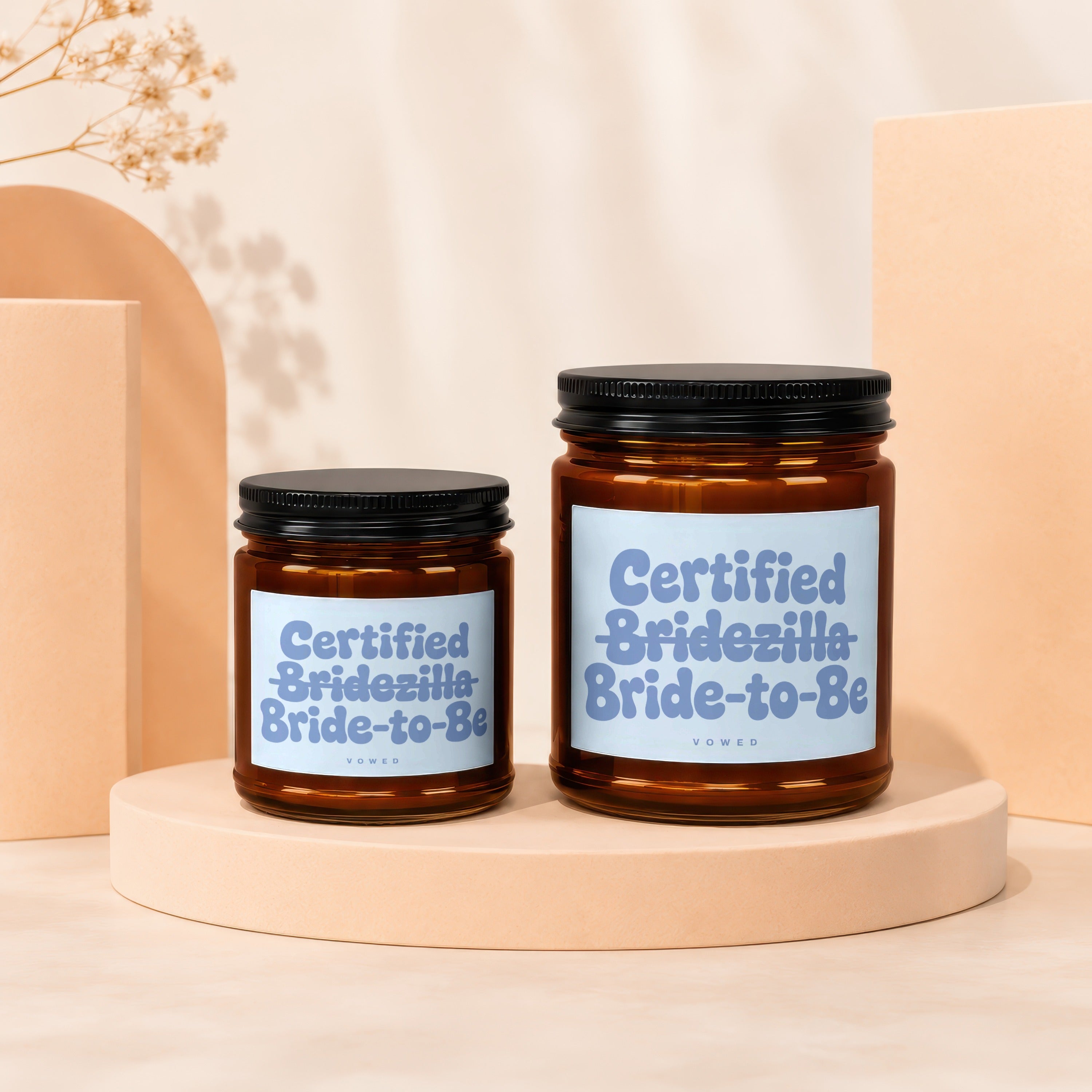 Two amber glass candles with black lids labeled "Certified Bridezilla Bride-to-Be."