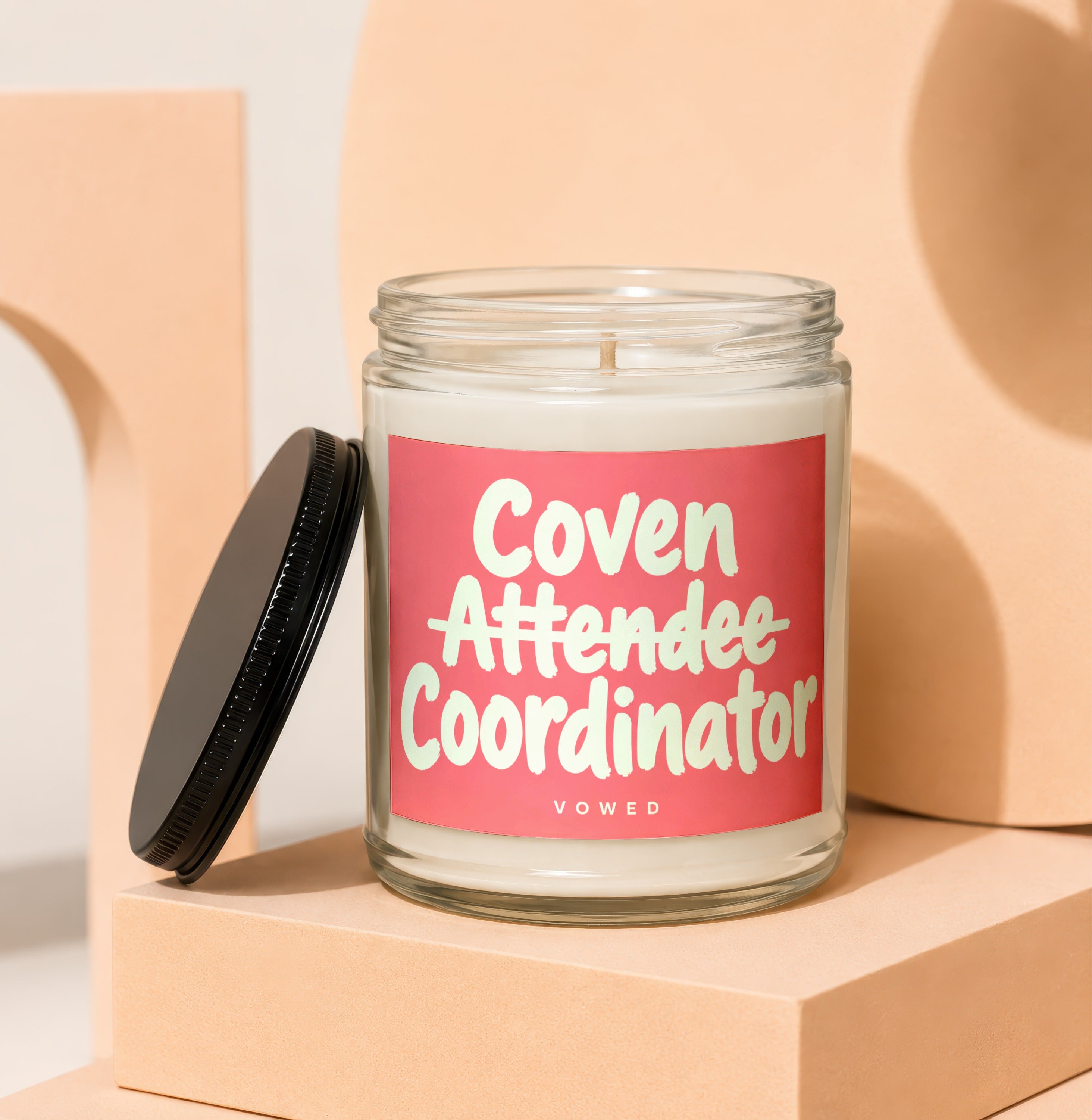Glass candle with "Coven Attendee Coordinator" text and "VOWED" at bottom.