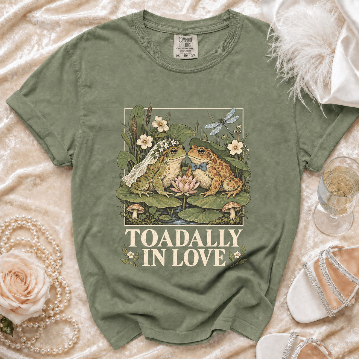 Green t-shirt with wedding frogs and "TOADALLY IN LOVE" text.