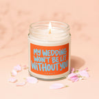 Lit candle in jar with orange label that reads "MY WEDDING WON'T BE LIT WITHOUT YOU."