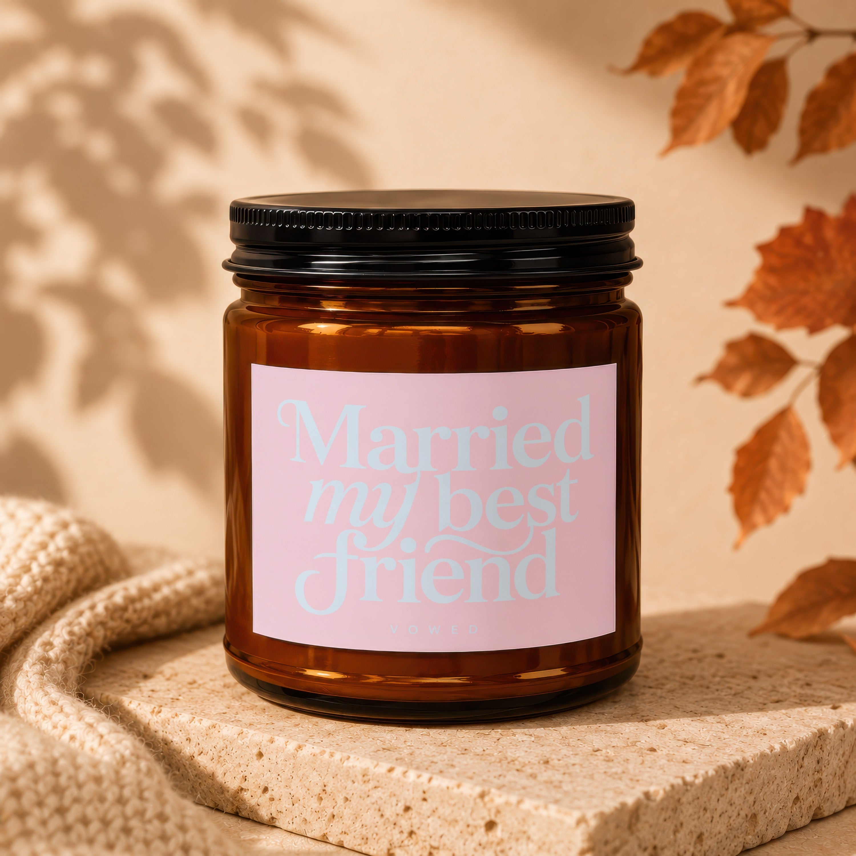 Amber glass candle with "Married my best friend" on a pink label.