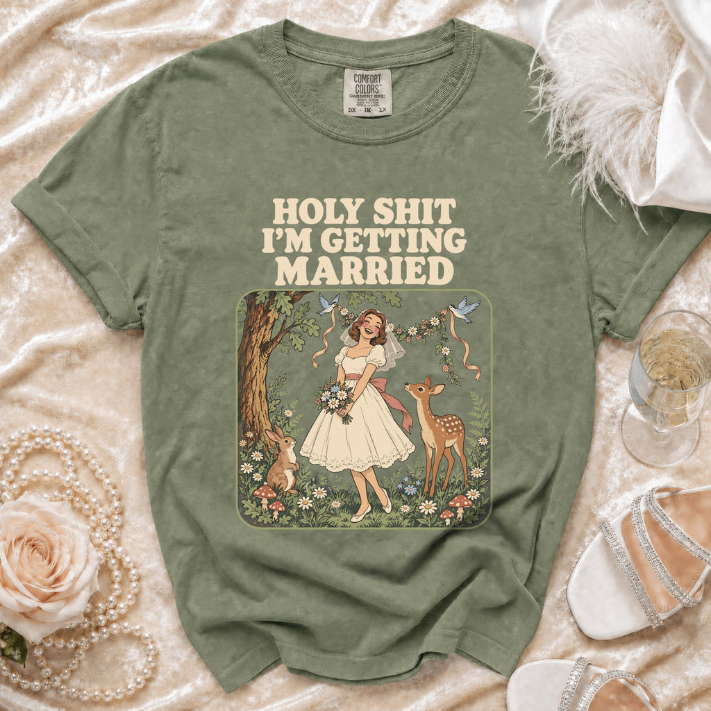 Olive green t-shirt with "HOLY SHIT I'M GETTING MARRIED" text and woodland bride graphic.