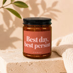 Amber glass candle with a coral label reading "Best day, best person" and "VOWED".