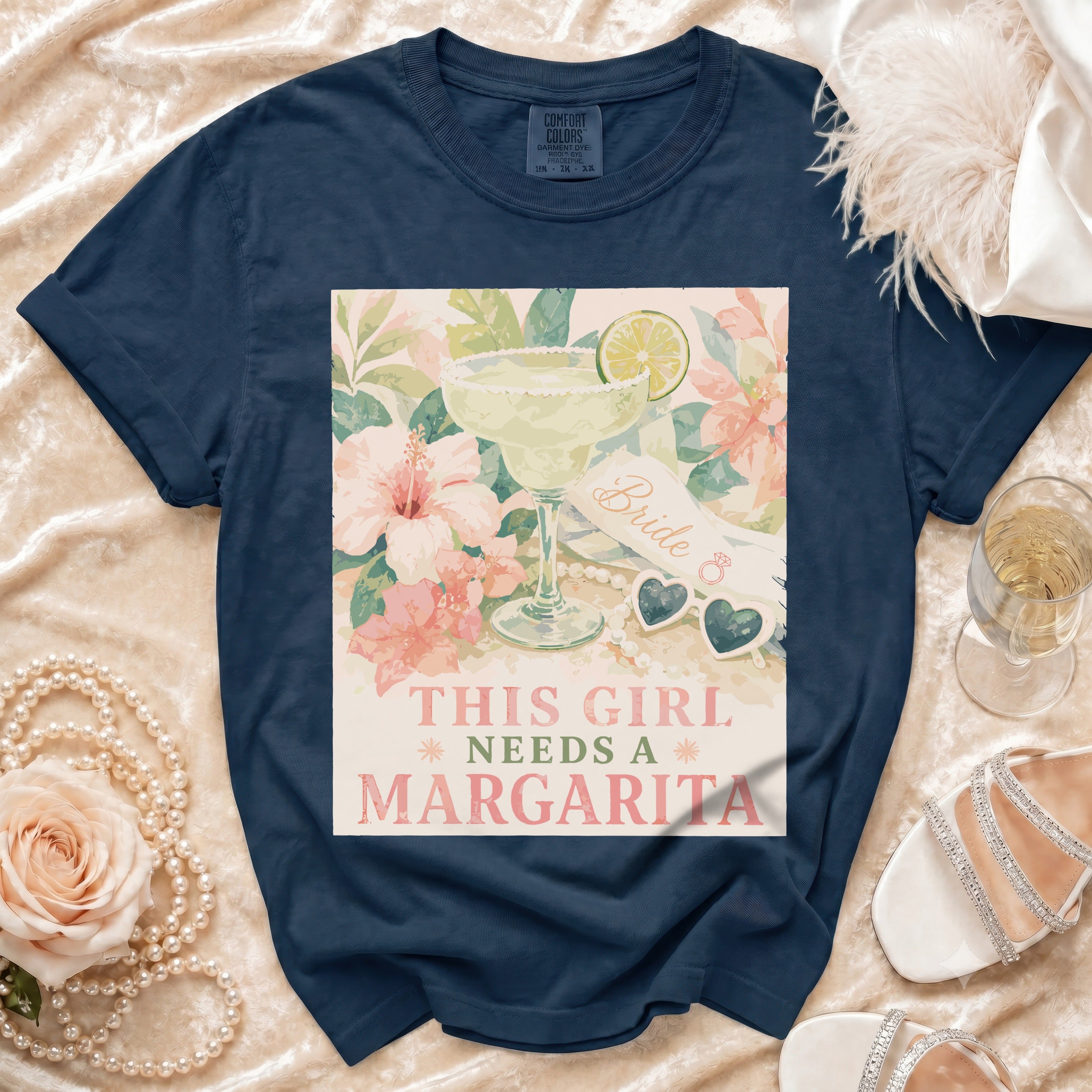 Navy t-shirt with graphic of margarita, flowers, and "This girl needs a margarita" text.