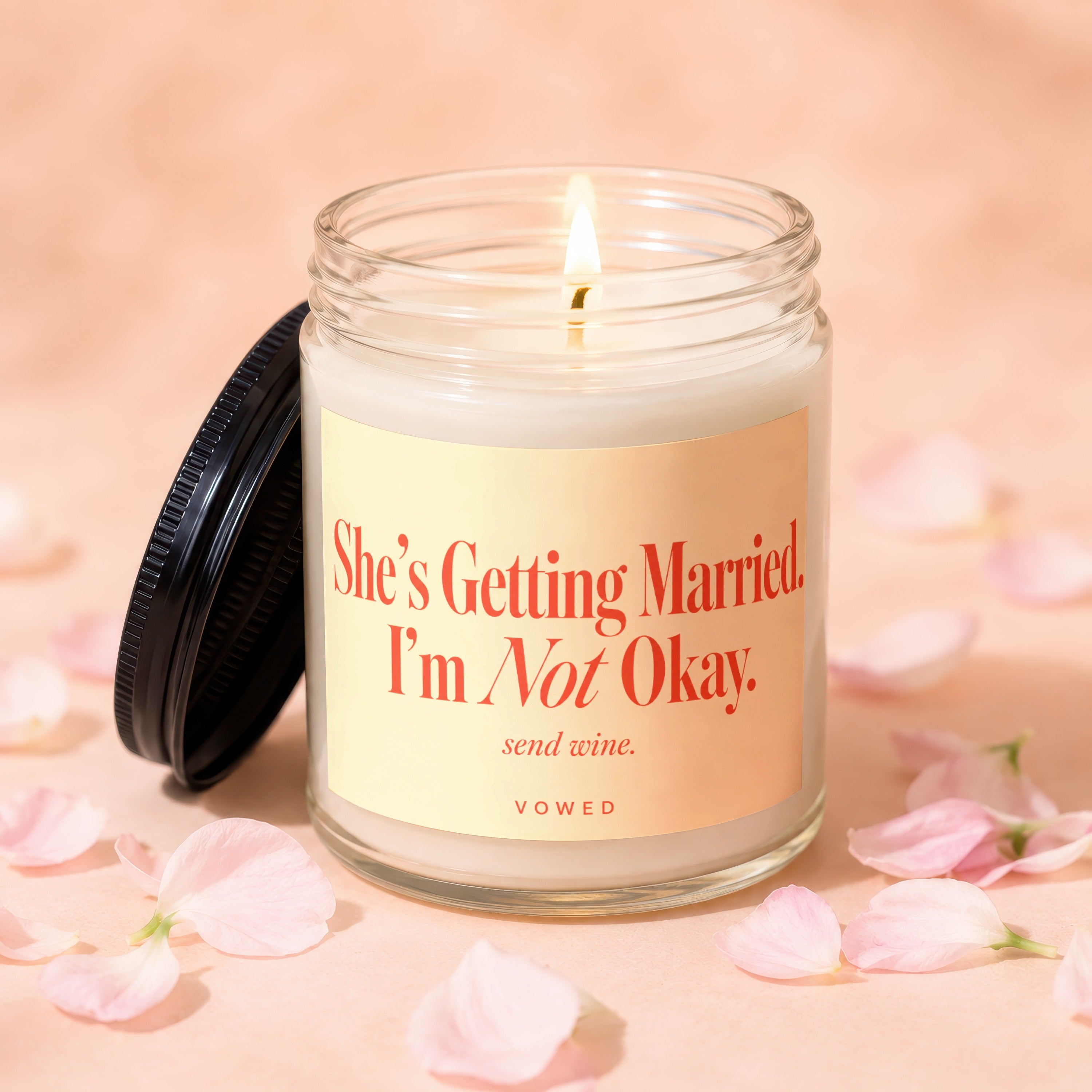 Candle with text "She's Getting Married. I'm Not Okay. send wine."