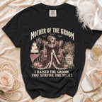 Black t-shirt with "Mother of the Groom, I Raised the Groom. You Survive the Night." text and skeleton graphic.