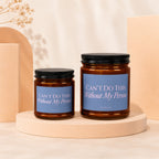 Two brown glass candles with blue labels reading "Can't Do This Without My Person."