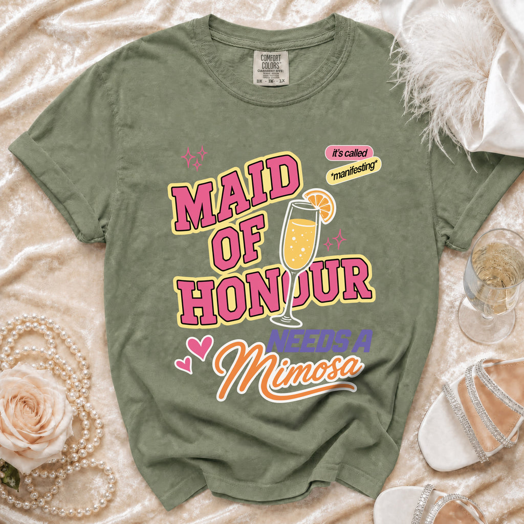 Green t-shirt with "MAID OF HONOUR NEEDS A Mimosa" text and mimosa graphic.