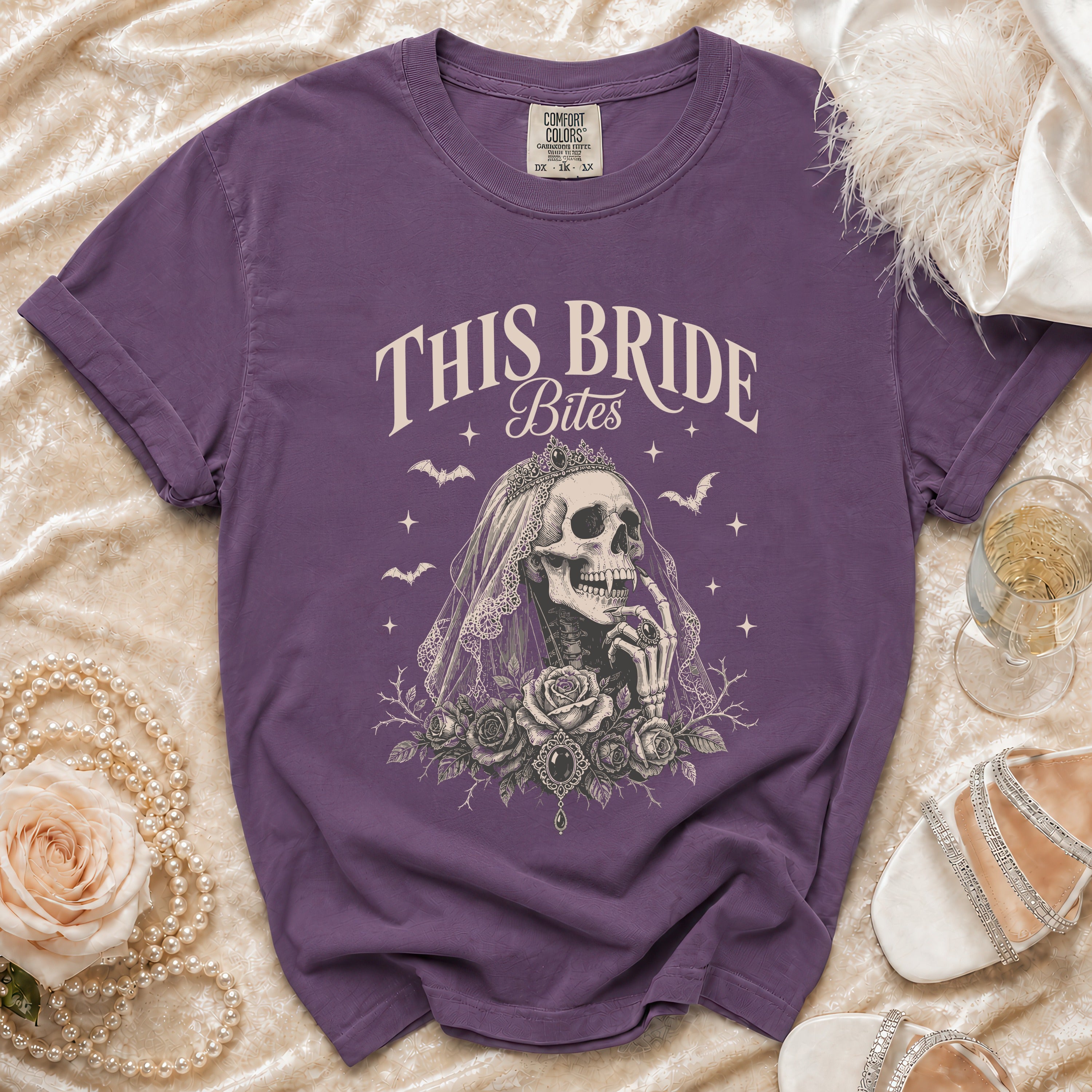 Purple t-shirt with "THIS BRIDE Bites" graphic of a skeleton bride and roses.