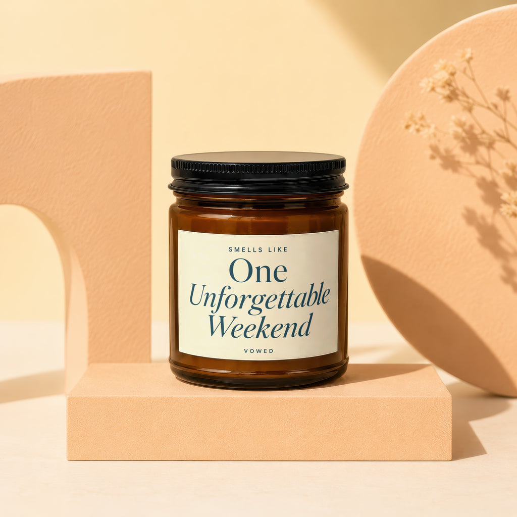 Brown glass candle with a label reading "Smells Like One Unforgettable Weekend"