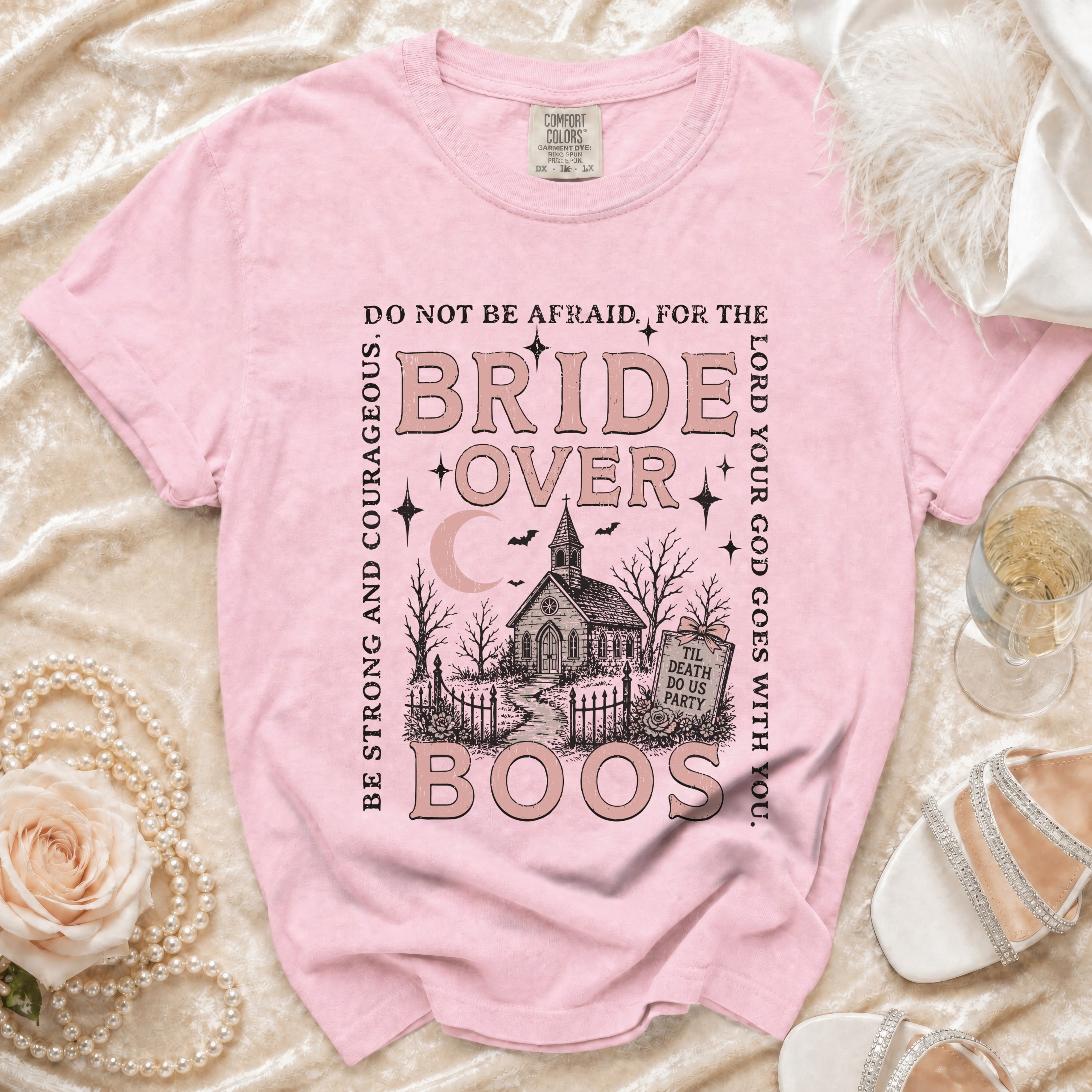 Pink t-shirt with "Bride Over Boos" graphic, a church, and spooky elements.