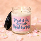 Candle with "Proud of You, Rested Tired for Me" text on a pink label.