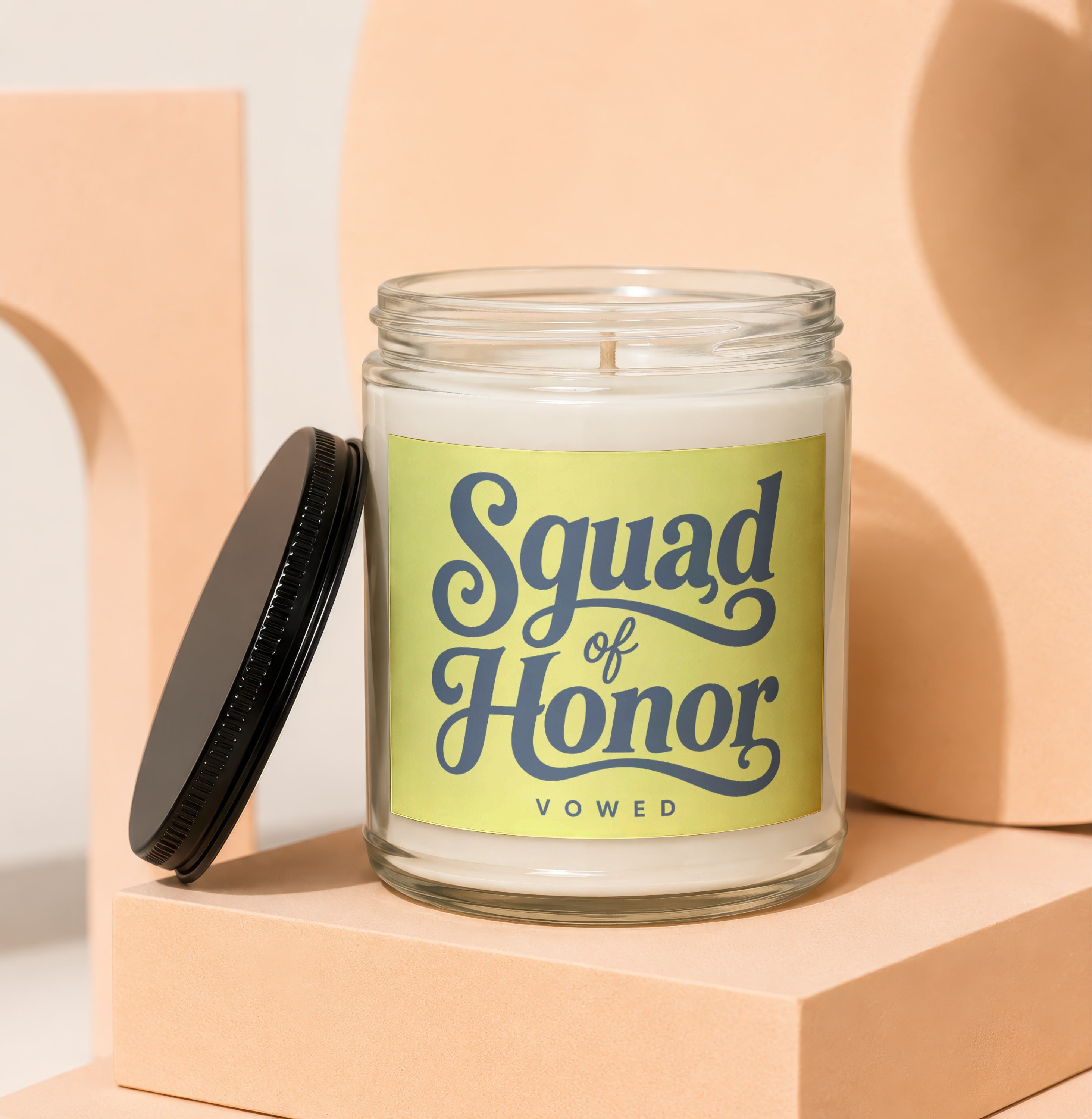 Glass candle with "Squad of Honor" text on a light green label.