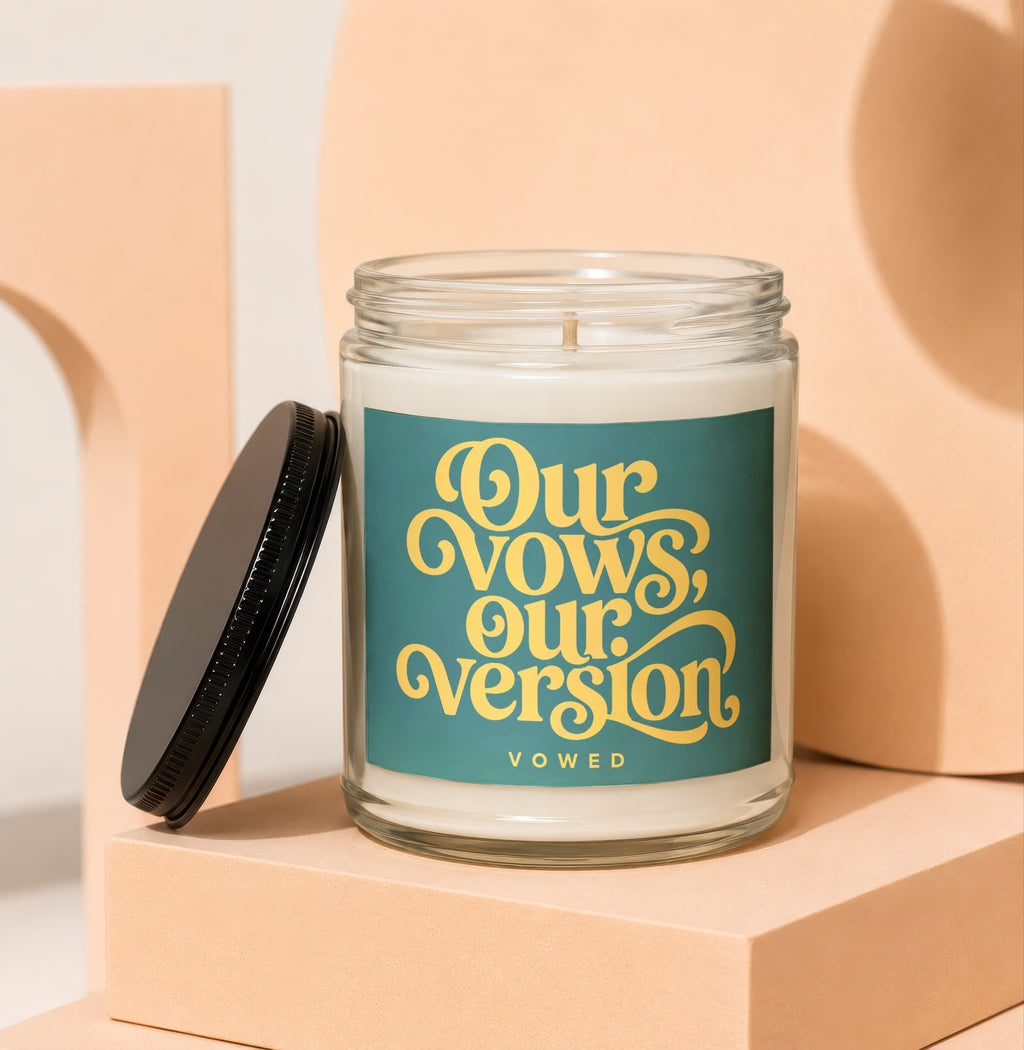 Candle with teal label featuring yellow text "Our Vows, Our Version".