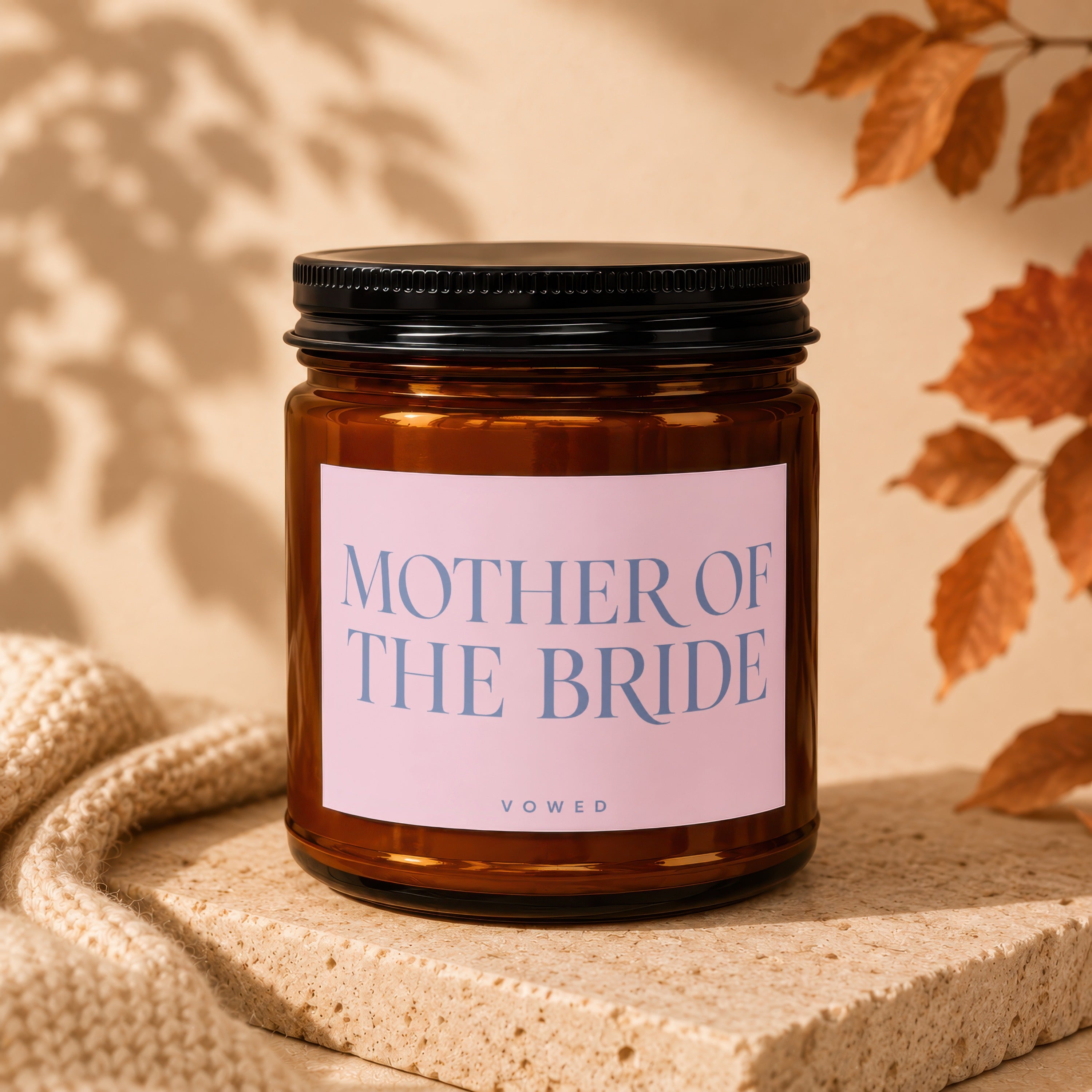 Amber jar candle with pink label reading "MOTHER OF THE BRIDE" and "VOWED".