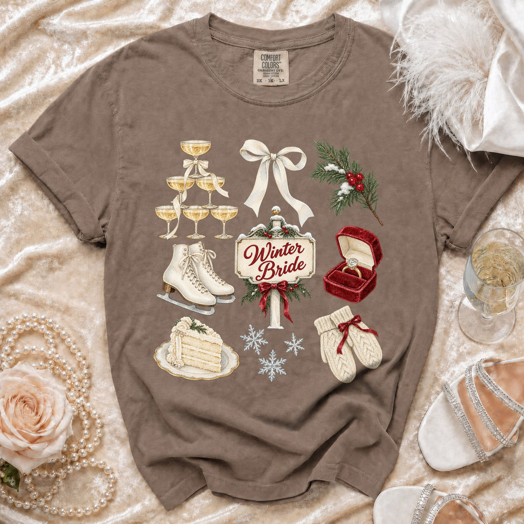 Brown t-shirt with Winter Bride graphic featuring ice skates, champagne, cake, and wedding ring.