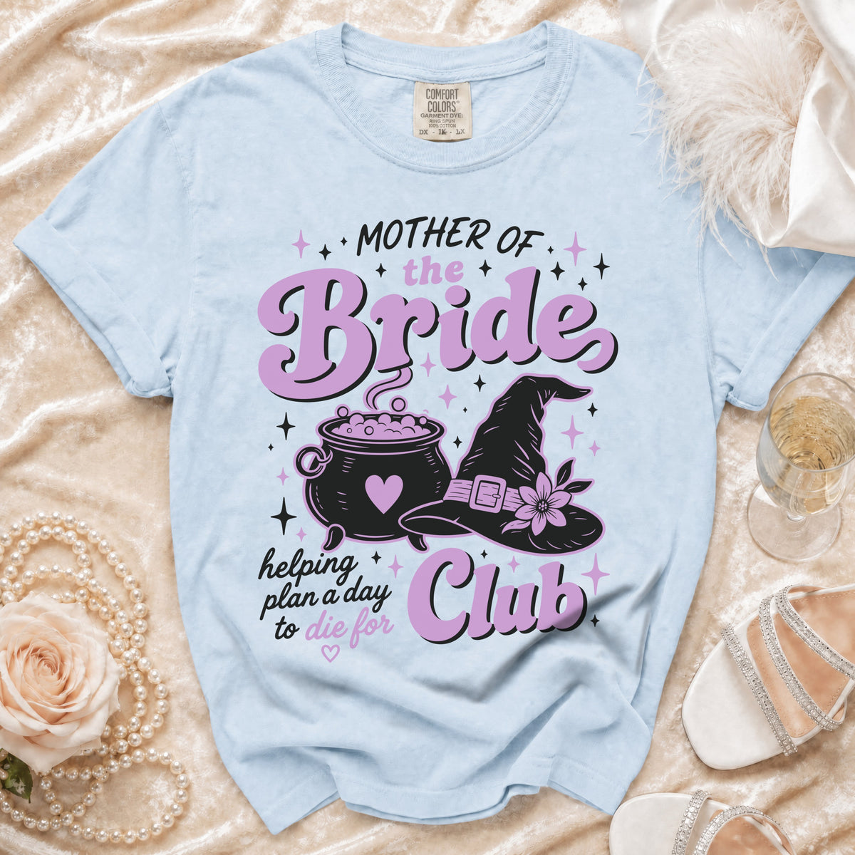Light blue t-shirt with "Mother of the Bride" and witchy graphics.