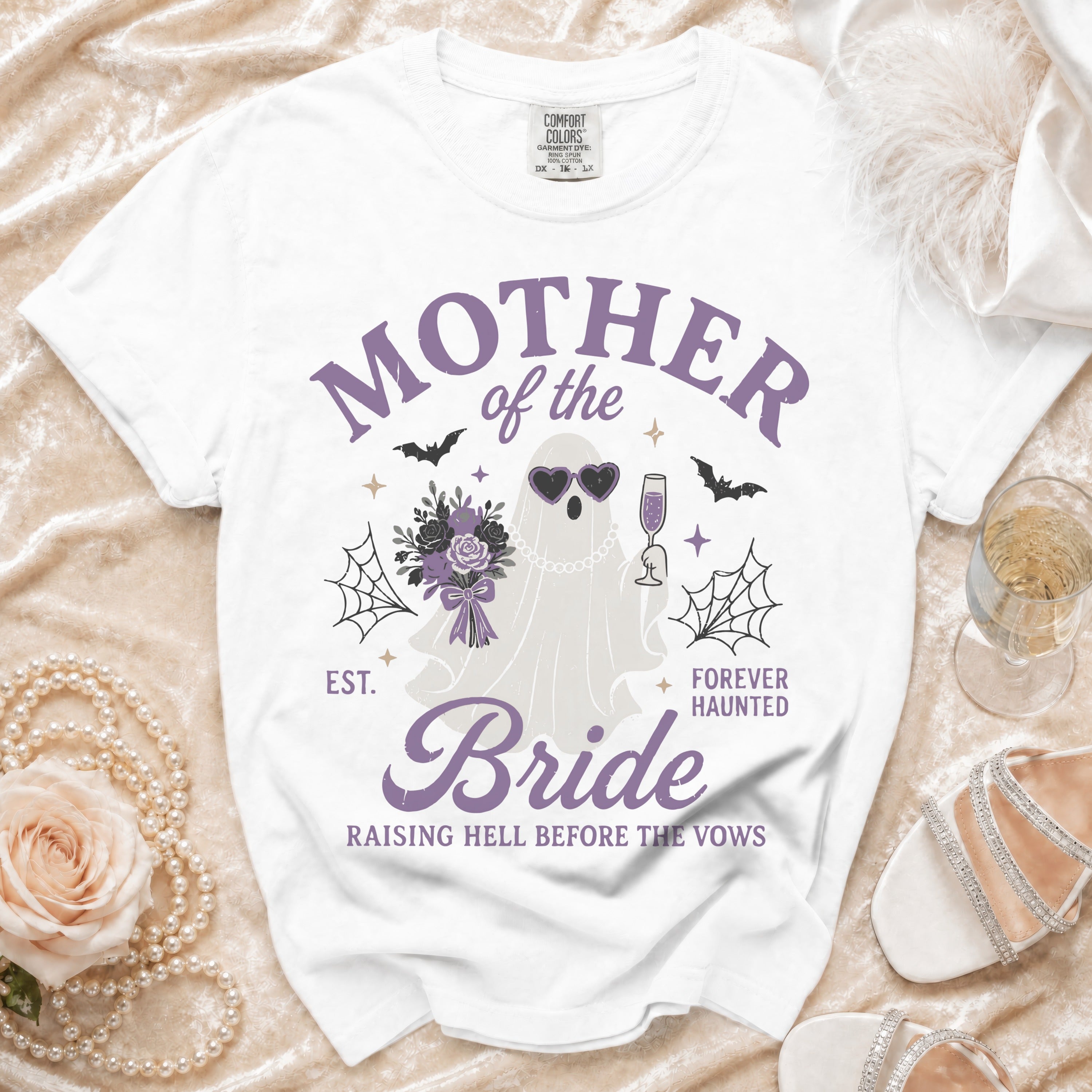 White t-shirt with "Mother of the Bride Forever Haunted" text and ghost graphic.