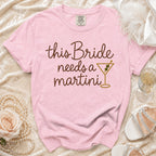 Pink t-shirt with "this Bride needs a martini" text and a martini glass graphic.