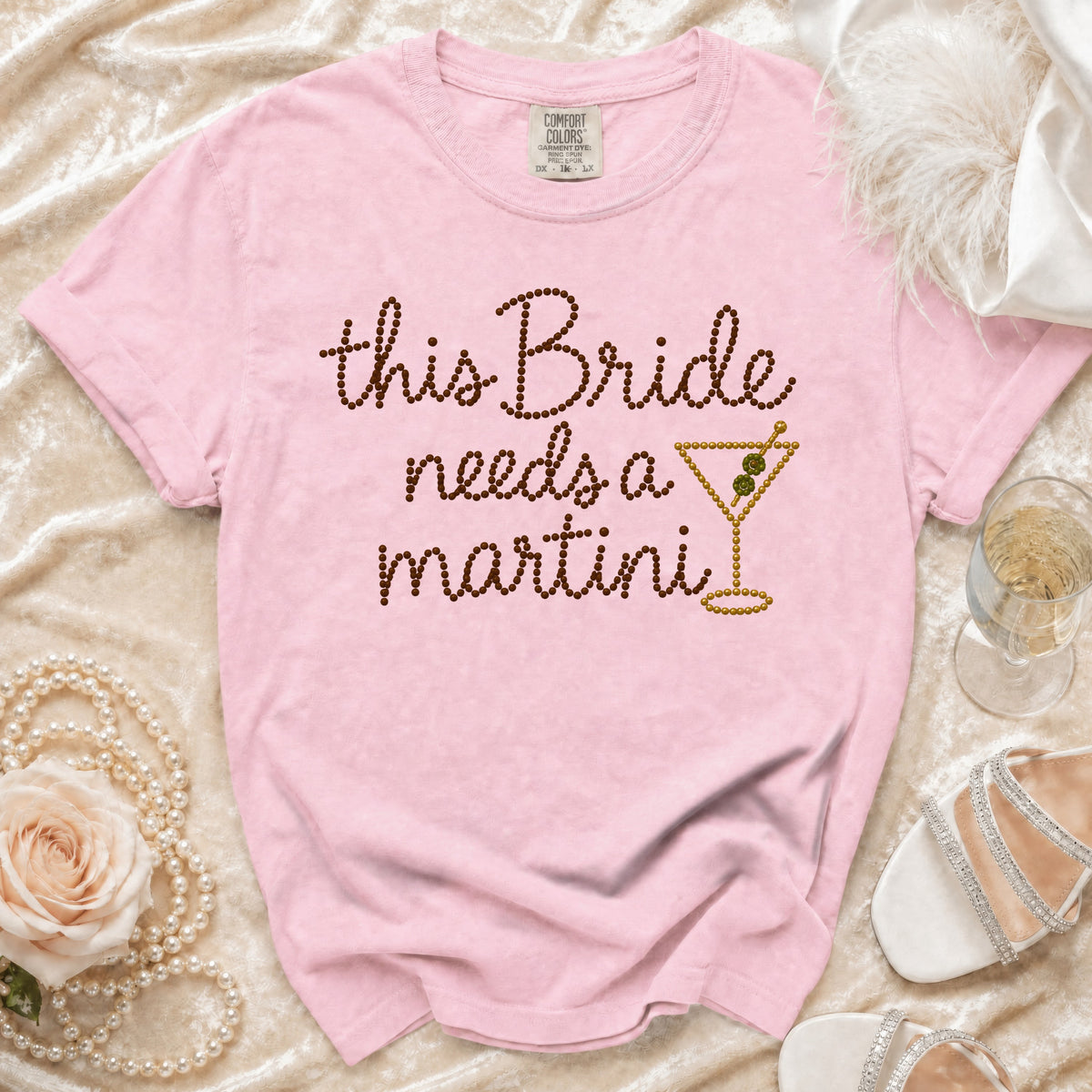 Pink t-shirt with "this Bride needs a martini" text and a martini glass graphic.