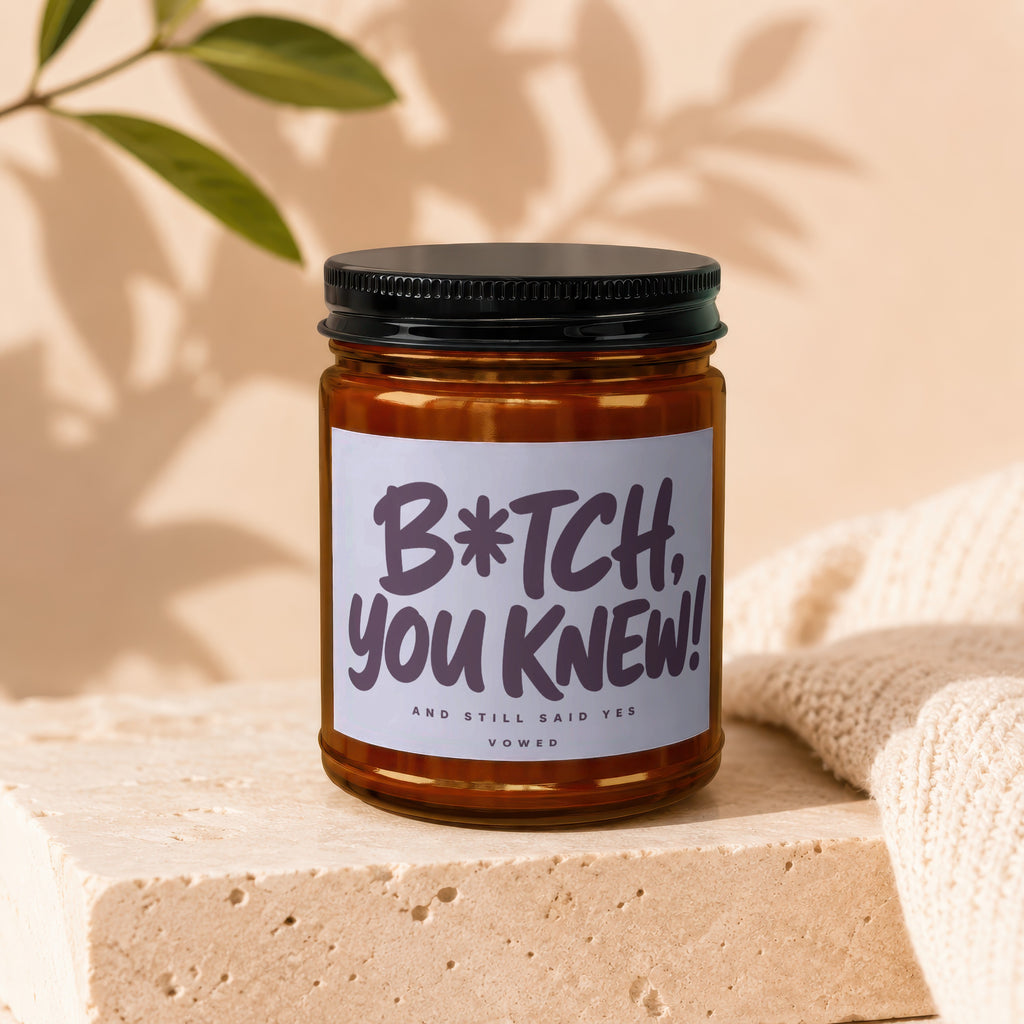 Amber jar candle with a label reading "B*tch, you knew! And still said yes. Vowed."