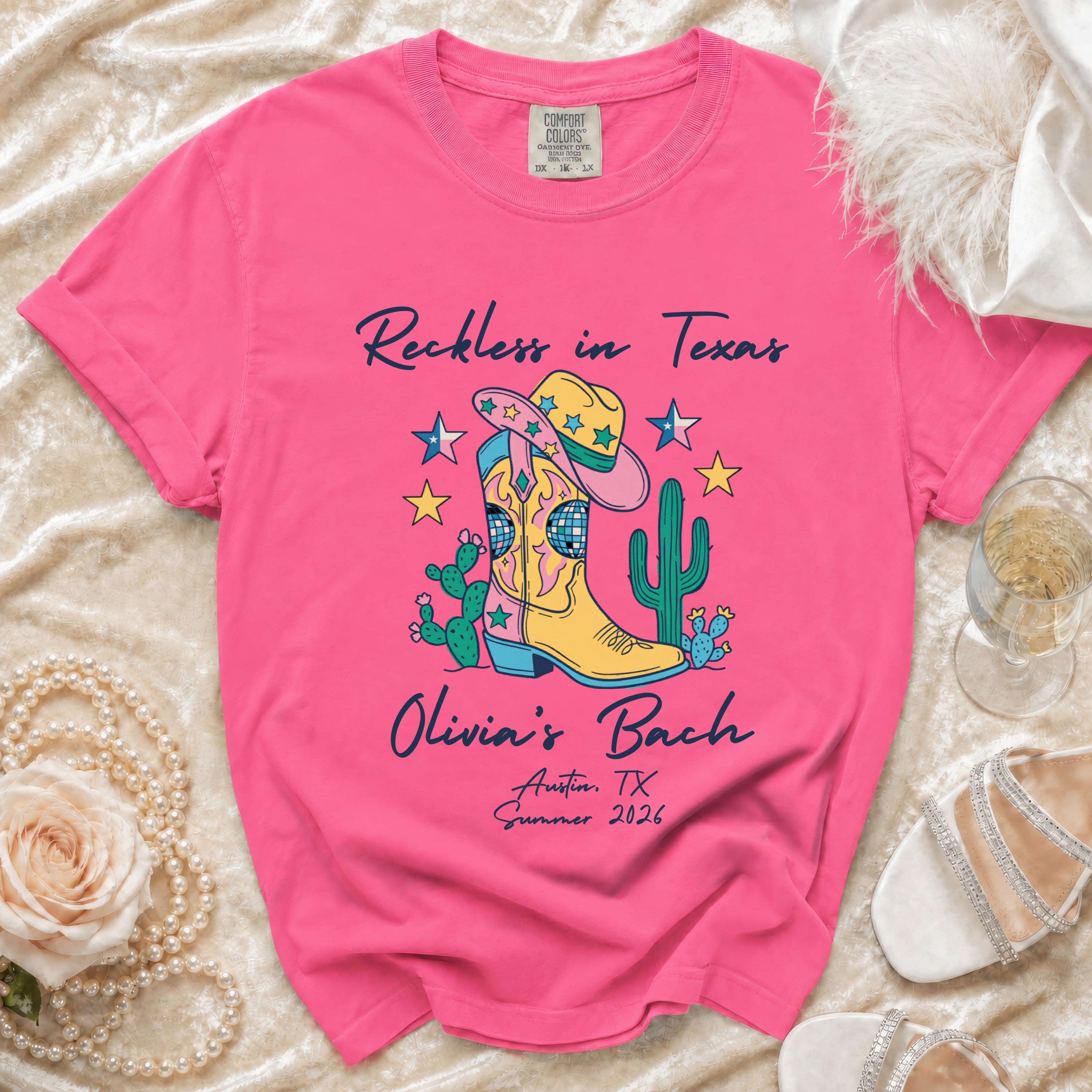Pink t-shirt with "Reckless in Texas" and "Olivia's Bach" design.