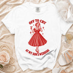 White t-shirt with red graphic of woman crying with martini and text "OFF TO CRY AT MY SON'S WEDDING".