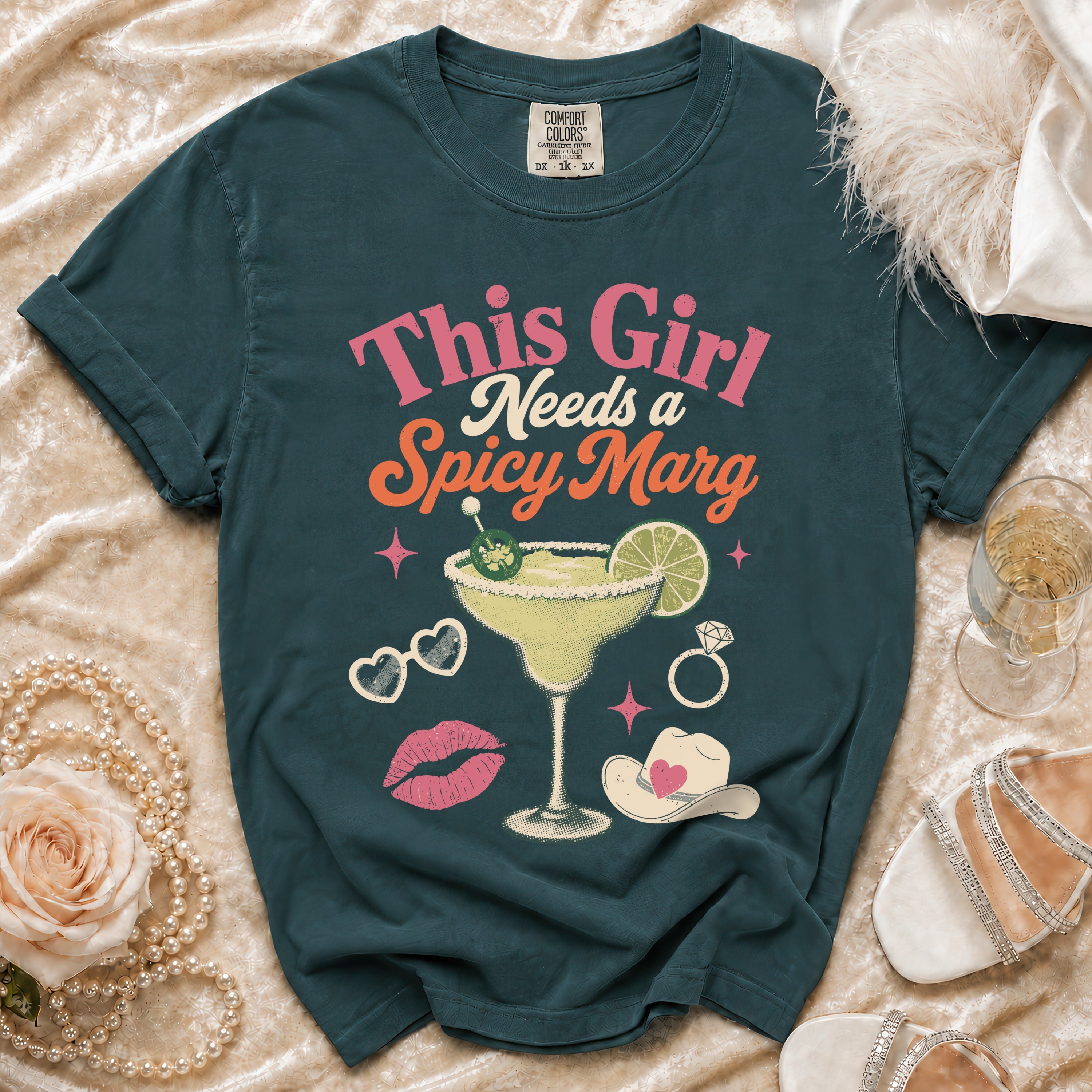 Teal t-shirt with "This Girl Needs a Spicy Marg" graphic and margarita.