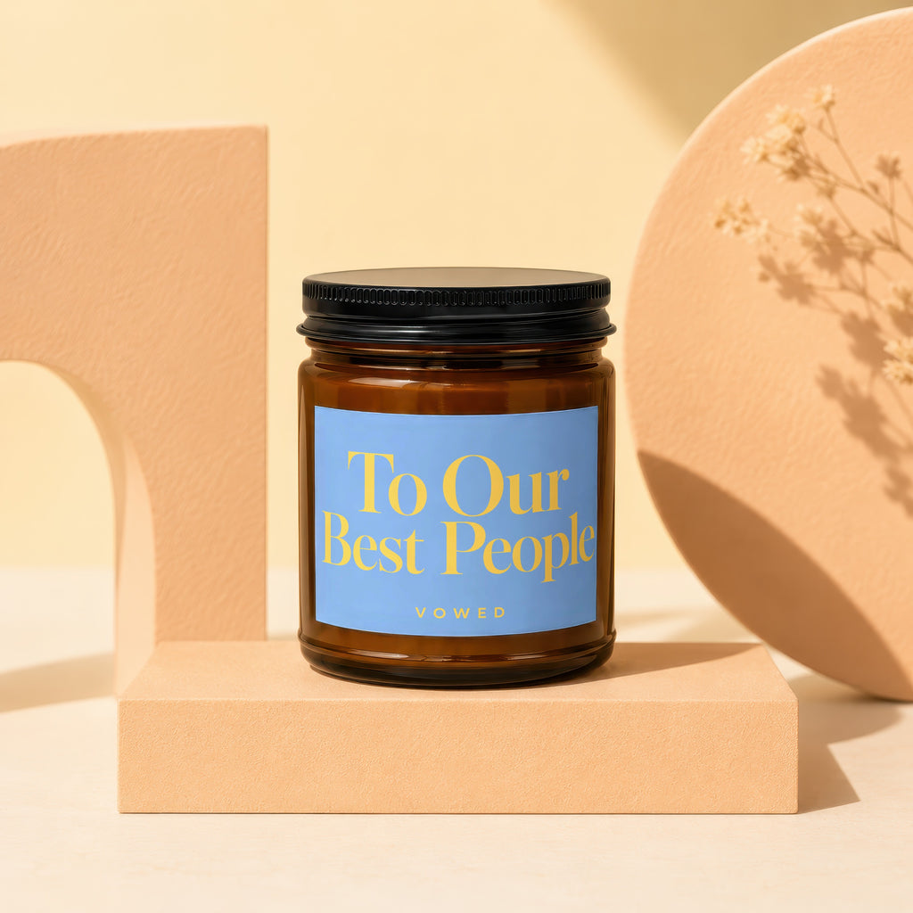 Candle with blue label reading "To Our Best People VOWED".