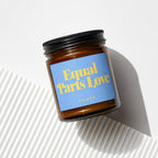 Amber jar candle with blue label reading "Equal Parts Love" and "VOWED".