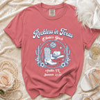 T-shirt with cowboy boots, hat, disco ball, and "Reckless in Texas Olivia's Bach Austin, TX Summer 2026".