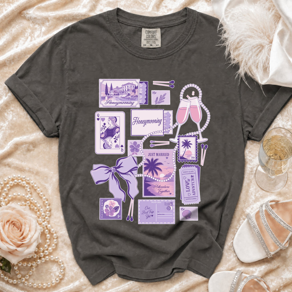 Dark grey t-shirt with a collage of purple honeymoon-themed illustrations and text.