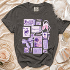 Dark grey t-shirt with a collage of purple honeymoon-themed illustrations and text.