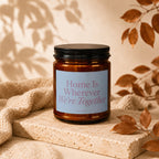Amber jar candle with black lid reads "Home Is Wherever We're Together."