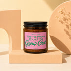 Glass jar candle with pink label: Smells Like The Yes Heard Round the Group Chat.