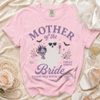 Pink t-shirt with "Mother of the Bride Forever Haunted" graphic.