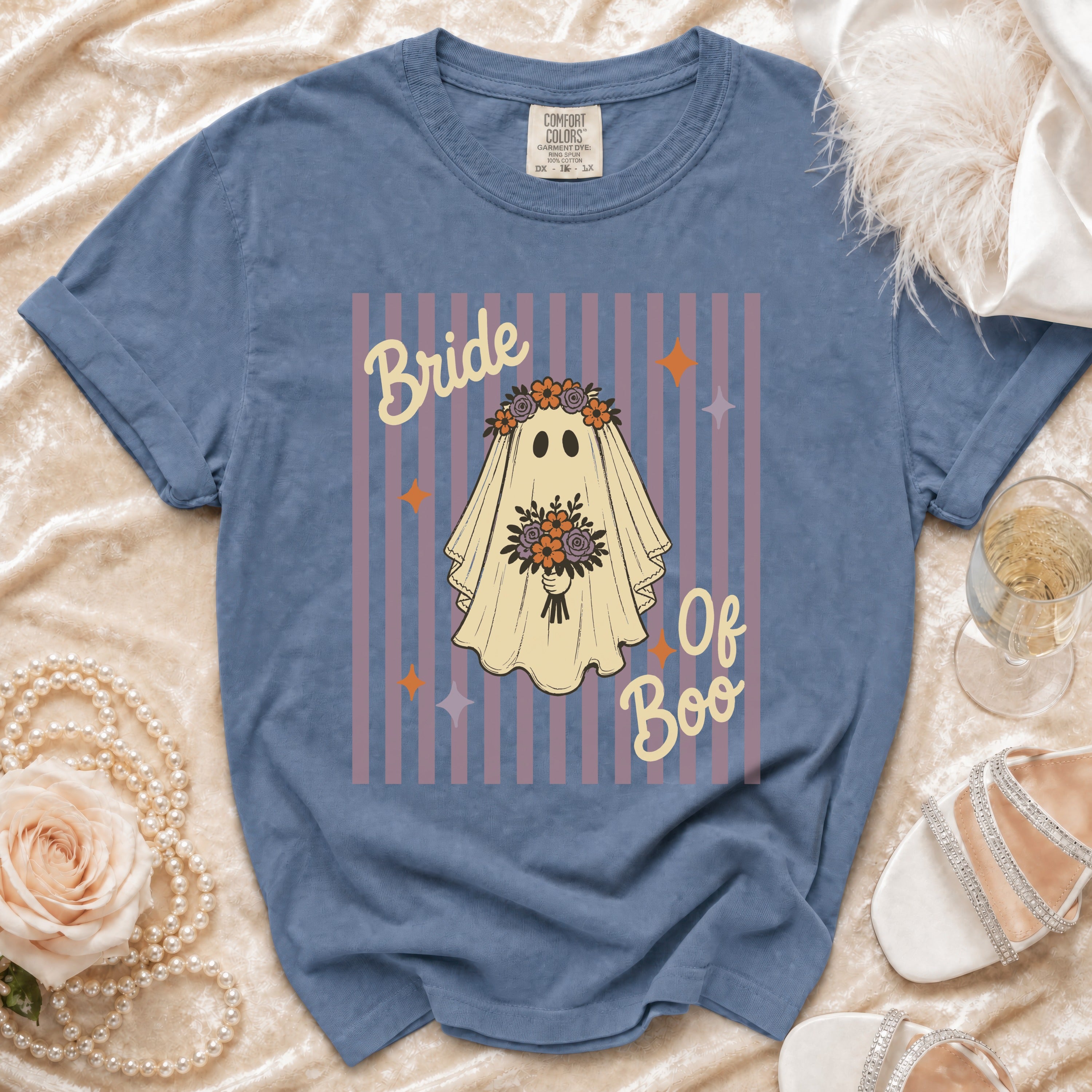 Blue t-shirt with ghost graphic reading "Bride Of Boo" on striped background.