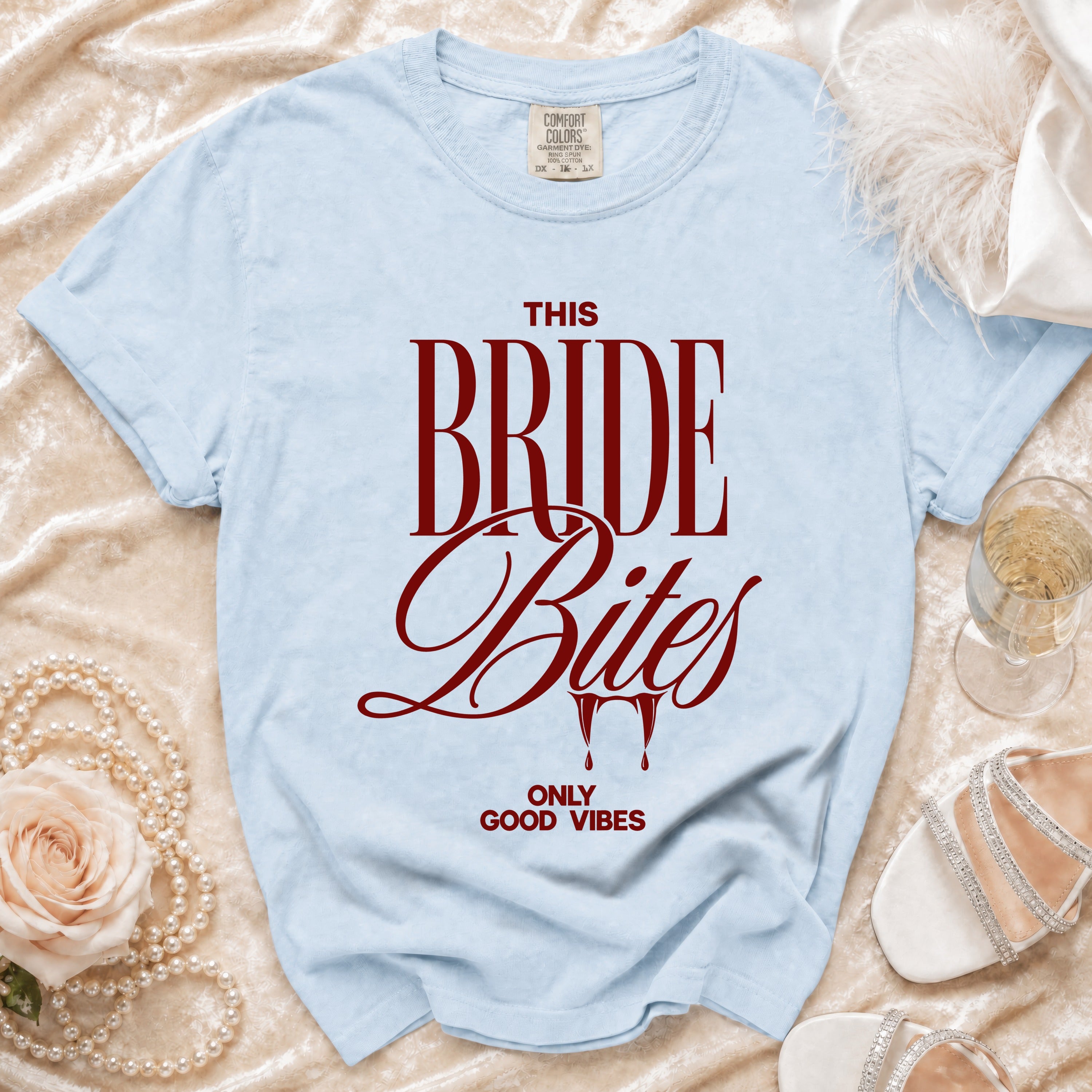 Light blue t-shirt with "THIS BRIDE Bites ONLY GOOD VIBES" in maroon text.