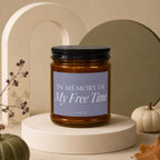 Amber candle labeled "IN MEMORY OF My Free Time" on a display pedestal.