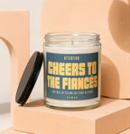 Candle with label "Attention: Cheers to the Fiances Vowed".