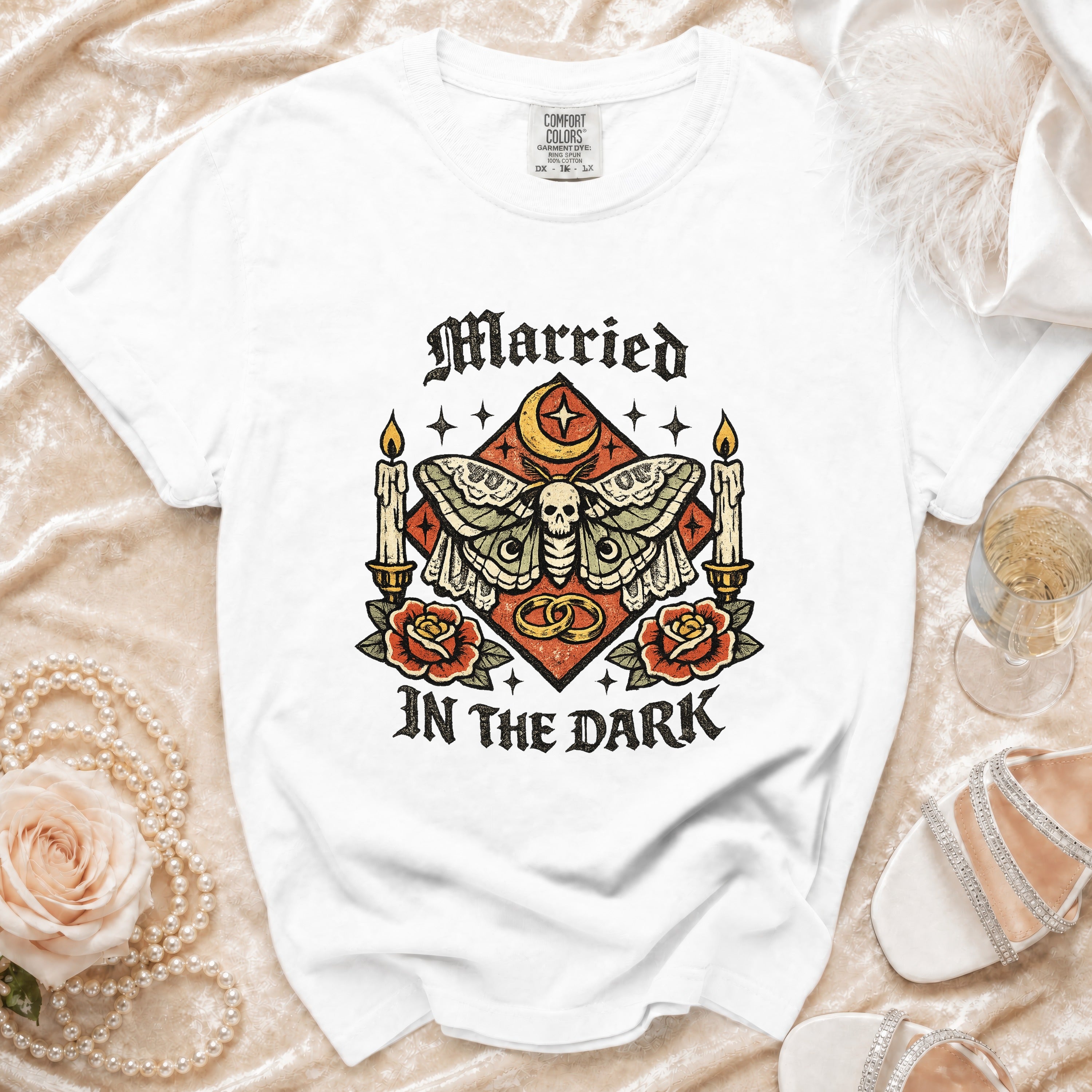 White t-shirt with "Married in the Dark" gothic moth graphic and ornate details.