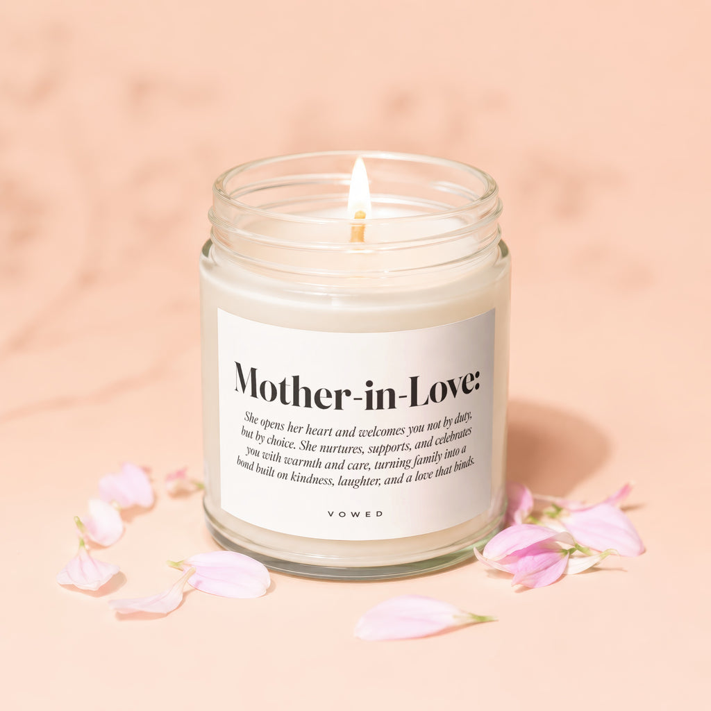 Mother-in-Love candle with descriptive text and pink petals scattered around.